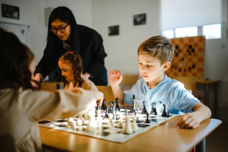 kids learning how to play chess