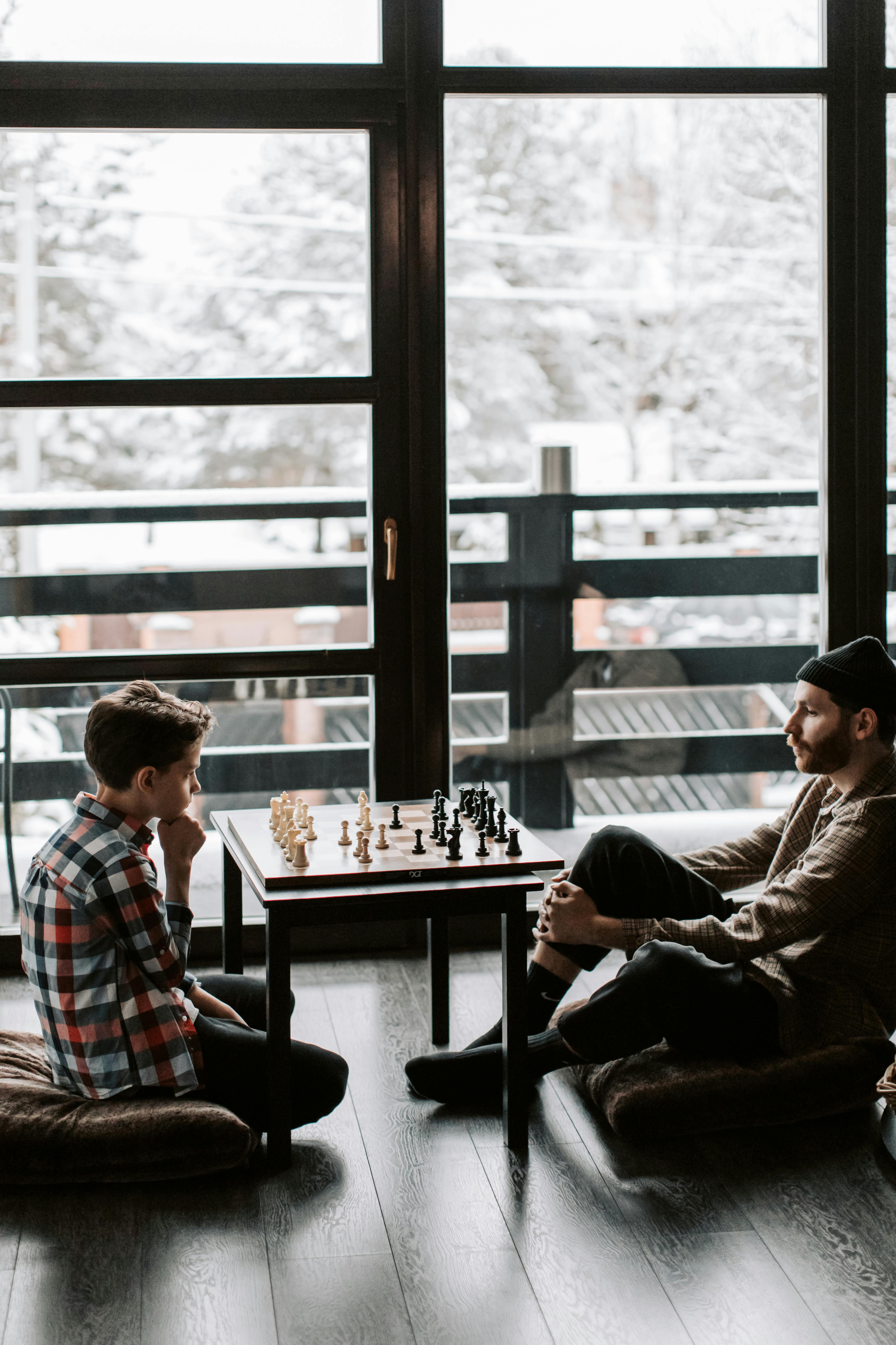 kid playing chess with the teacher